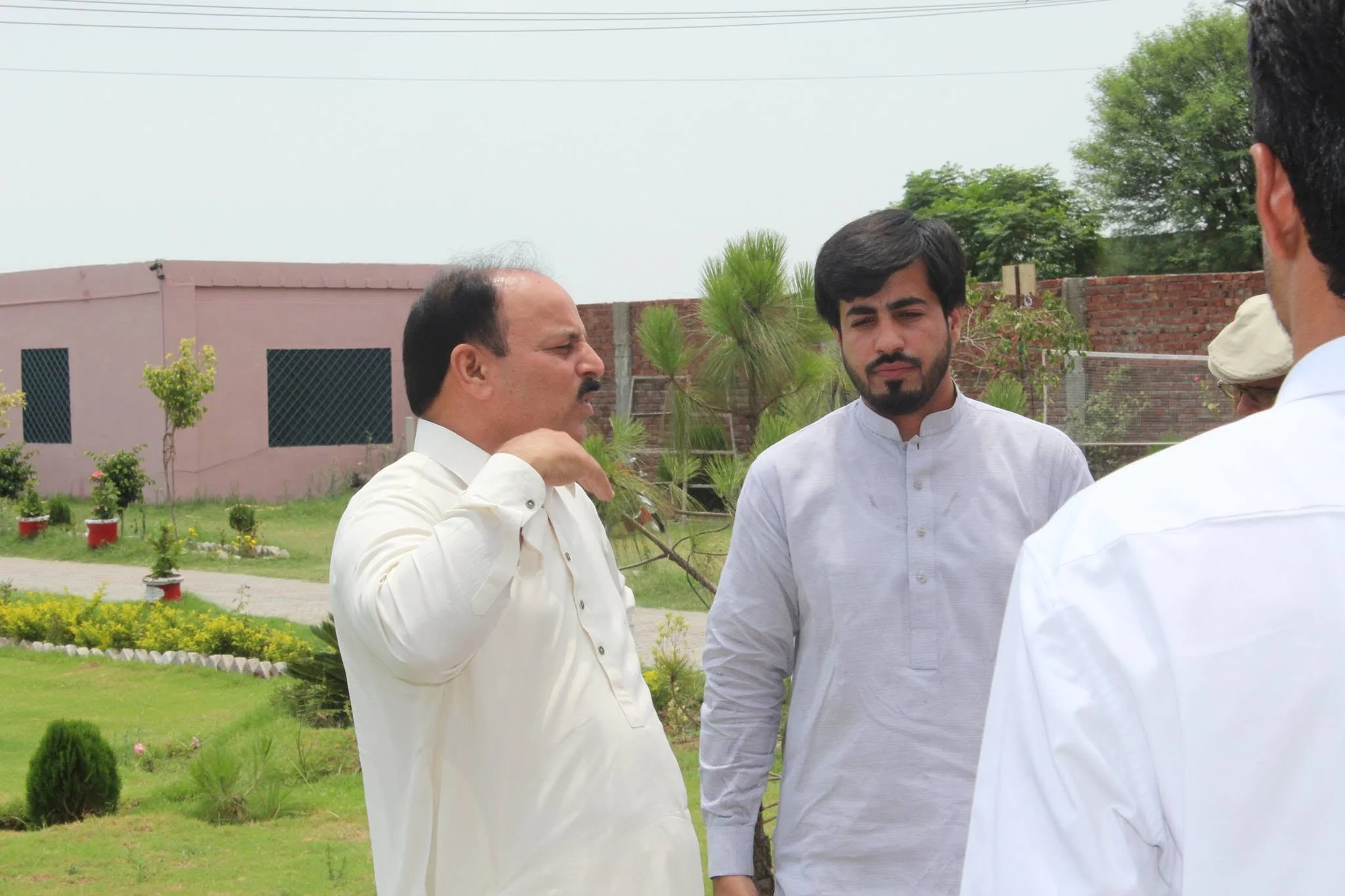 Ch. Muhammad Aslam Sikho with Faruukh Nadeem during the campus tour at Danish International Grammar School in 2014.