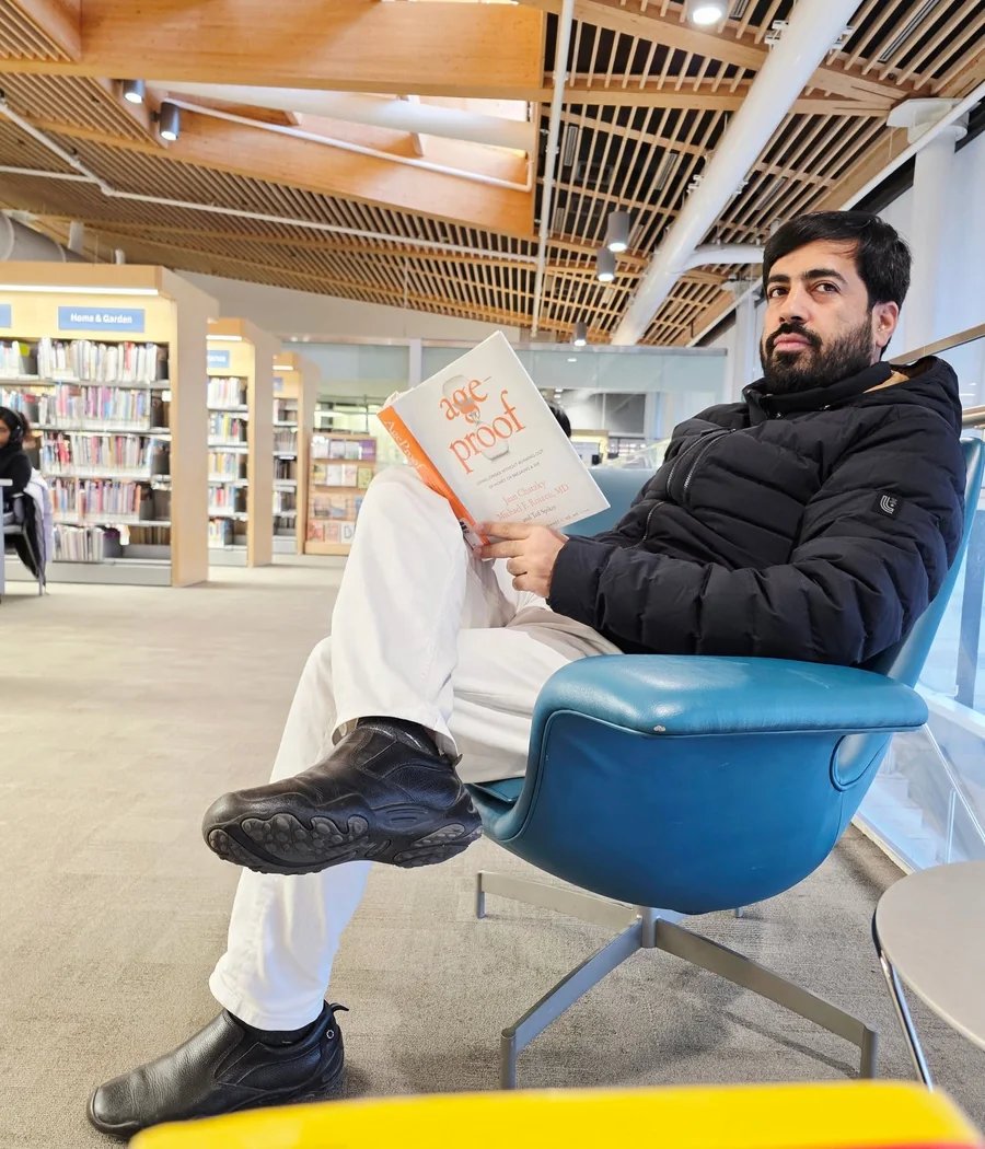 Faruukh Nadeem reading in a library