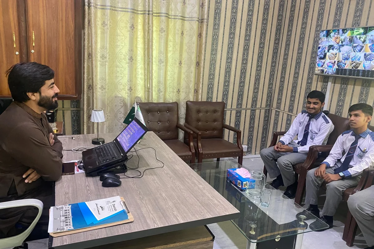 Faruukh Nadeem meeting students in a school office